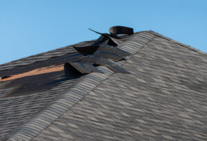 A house with wind damage to roof shingles.