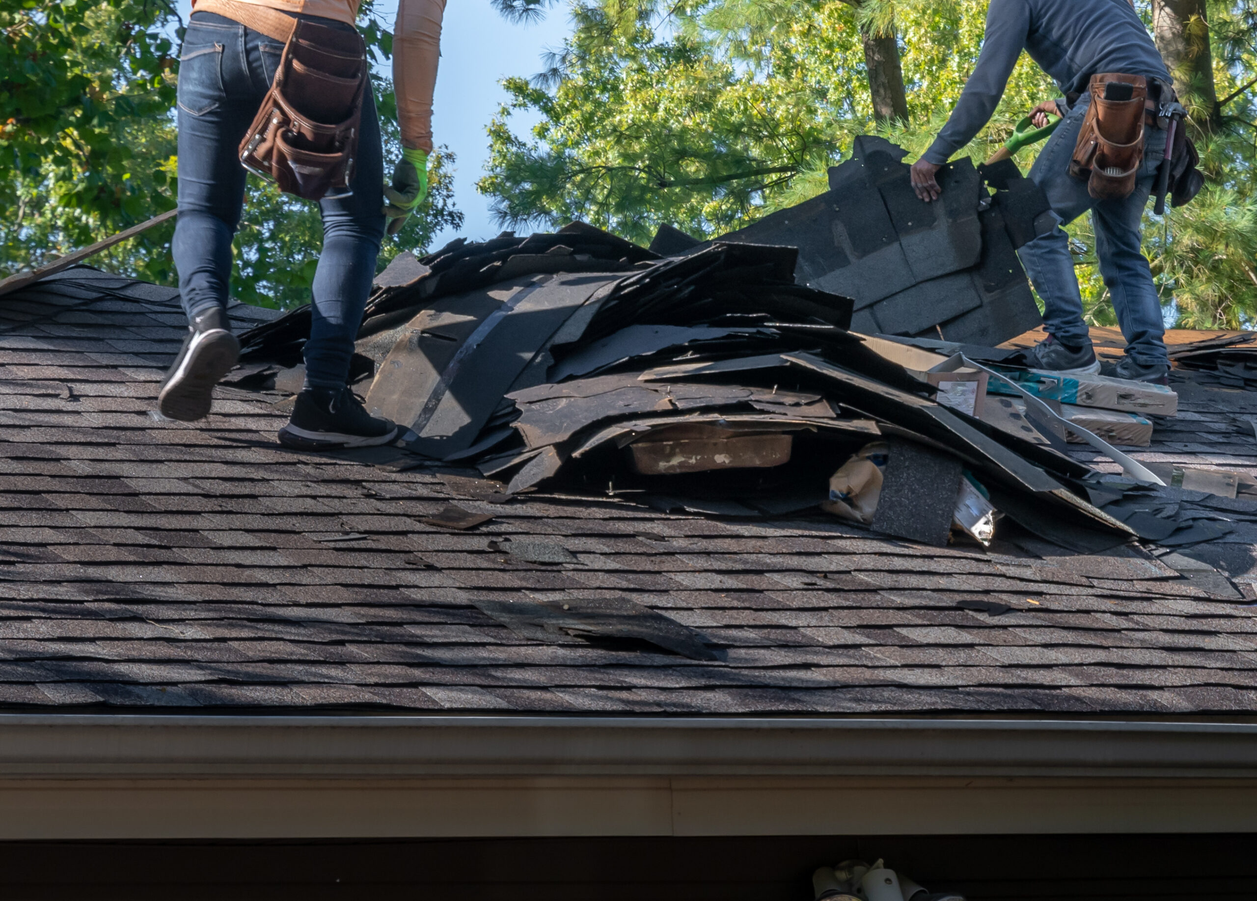 Roofing materials being torn off the roof.